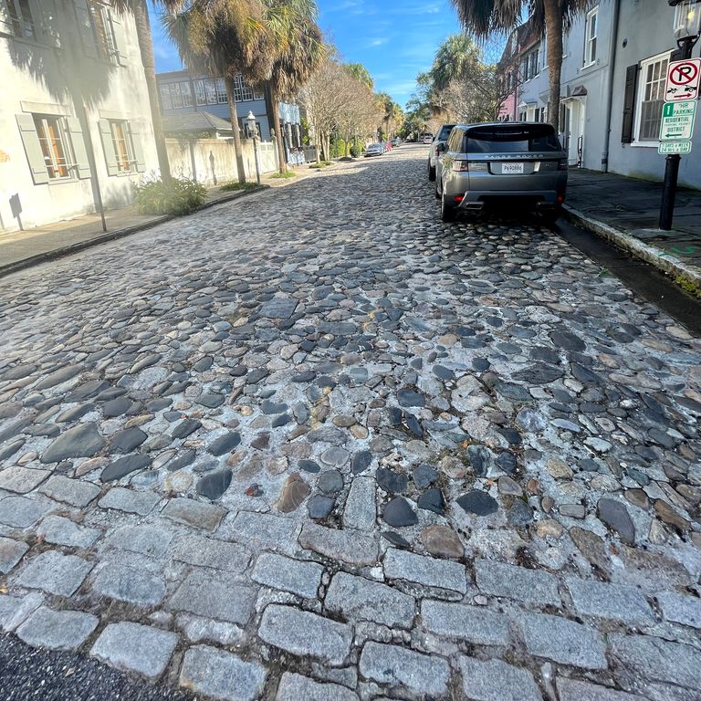 Application image for Beach Rounds - Pavers. The image shows this product being used in a driveway pavers application. The dominant color shown is gray.