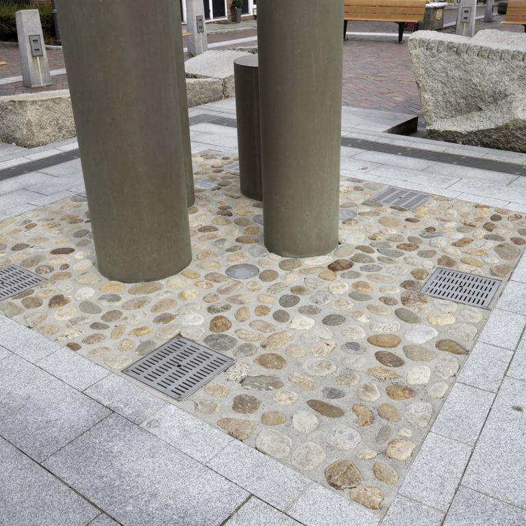 Application image for Beach Rounds - Pavers. The image shows this product being used in a water features application. The dominant color shown is gray.