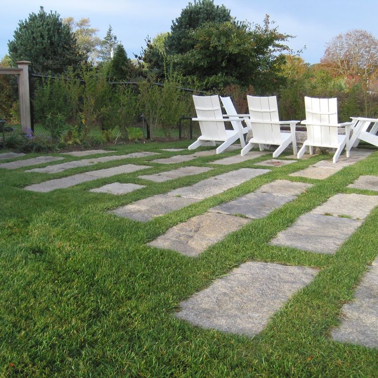Feature image for Reclaimed Granite Rustic Plank Pavers. The image shows this product being used in a patio pavers application. The dominant color shown is gray; with beige, brown, orange/rust, purple and tan secondaries. Exhibits 