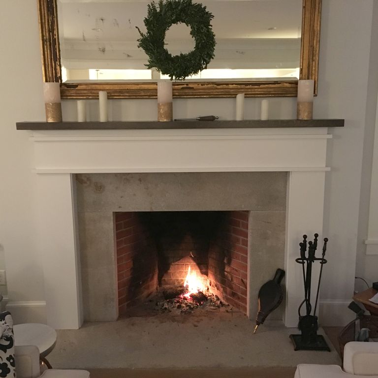 Application image for Reclaimed Granite Fire Feature. The image shows this product being used for fireplace hearth and fireplace surround. This is a building and landscape stone for indoor and outdoor residential applications. Suitable for general use situations. Higher to high on the price spectrum.