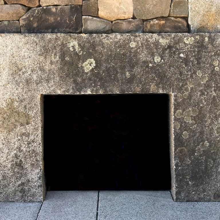 Application image for Reclaimed Granite Fire Feature. The image shows this product being used in a fireplace surround application. This is a building and landscape stone for indoor and outdoor residential applications. Suitable for general use, freeze-thaw conditions and low heat absorption surfaces situations. Higher to high on the price spectrum.