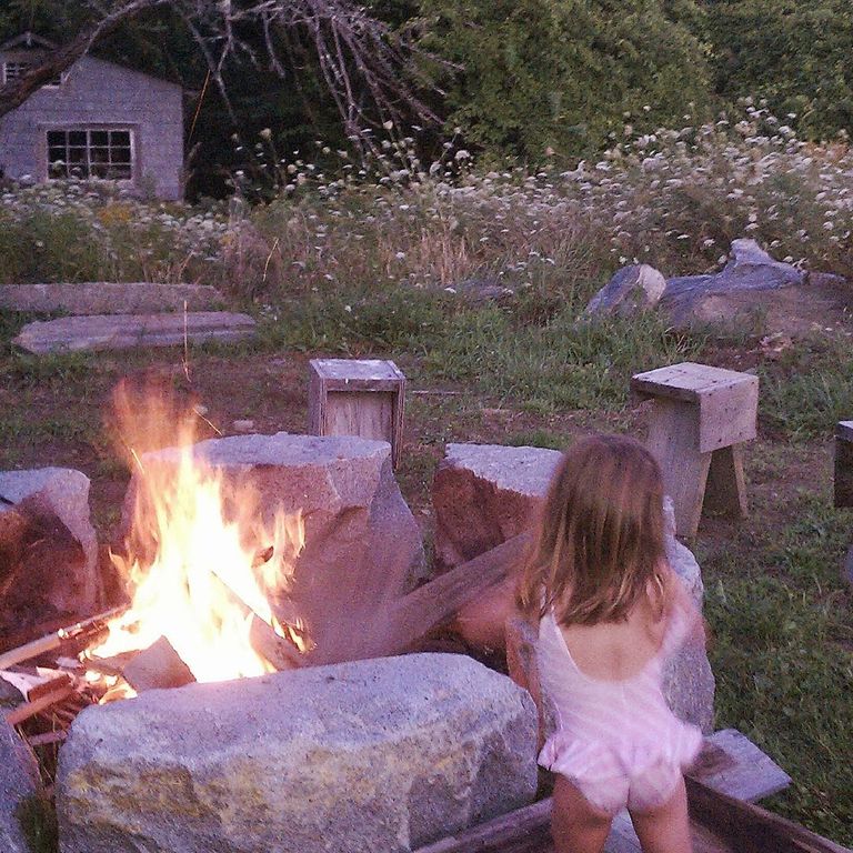 Application image for Reclaimed D-Radius Curbstone Fire Pit. The image shows this product being used in an outdoor fire concepts application. This is a landscape stone for outdoor residential applications. Suitable for general use, freeze-thaw conditions and low heat absorption surfaces situations. Relatively higher in price.