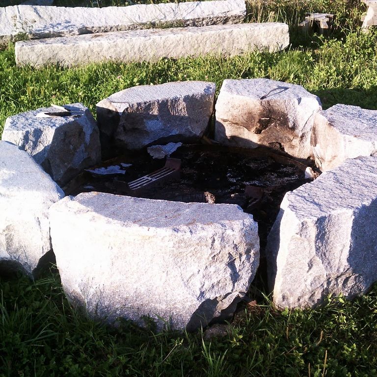 Application image for Reclaimed D-Radius Curbstone Fire Pit. The image shows this product being used in an outdoor fire concepts application. This is a landscape stone for outdoor residential applications. Suitable for general use, freeze-thaw conditions and low heat absorption surfaces situations. Relatively higher in price.