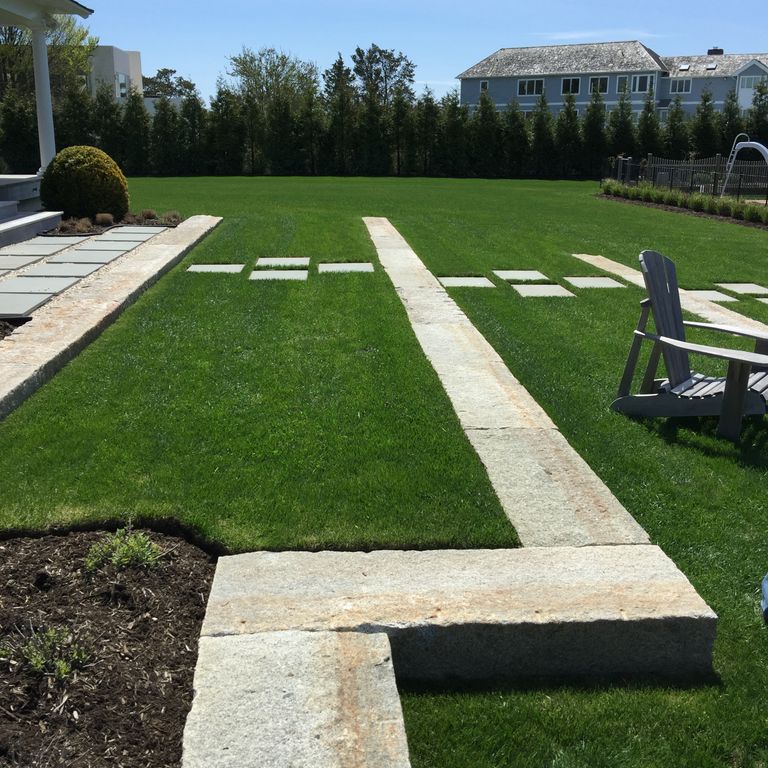 Application image for Reclaimed First Generation Granite Curbstone - Lawn Steps. The image shows this product being used in a monolithic steps application. This is a building and landscape stone for outdoor commercial and residential applications. Suitable for general use, freeze-thaw conditions, low heat absorption surfaces, high traffic areas and low slipperiness surfaces situations. Moderate to higher on the price spectrum.
