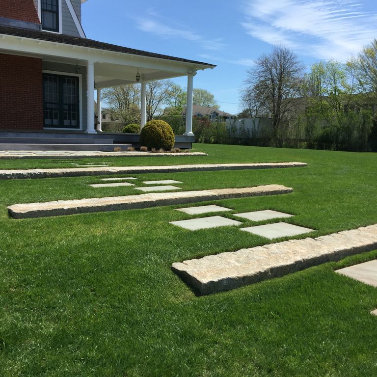 Application image for Reclaimed First Generation Granite Curbstone - Lawn Steps. The image shows this product being used in a monolithic steps application. This is a building and landscape stone for outdoor commercial and residential applications. Suitable for general use, freeze-thaw conditions, low heat absorption surfaces, high traffic areas and low slipperiness surfaces situations. Moderate to higher on the price spectrum.