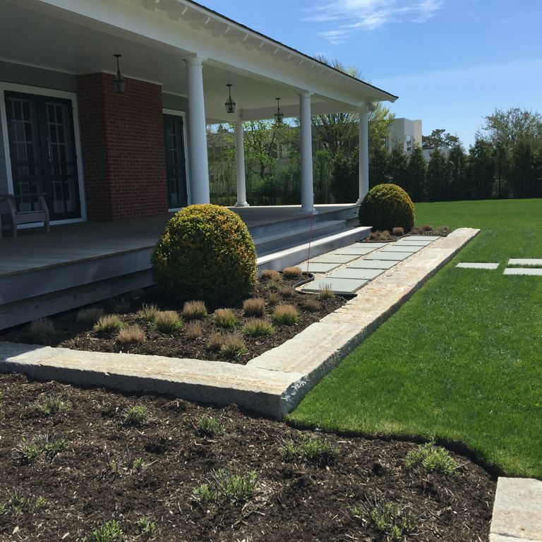 Application image for Reclaimed First Generation Granite Curbstone - Lawn Steps. The image shows this product being used in a monolithic steps application. This is a building and landscape stone for outdoor commercial and residential applications. Suitable for general use, freeze-thaw conditions, low heat absorption surfaces, high traffic areas and low slipperiness surfaces situations. Moderate to higher on the price spectrum.