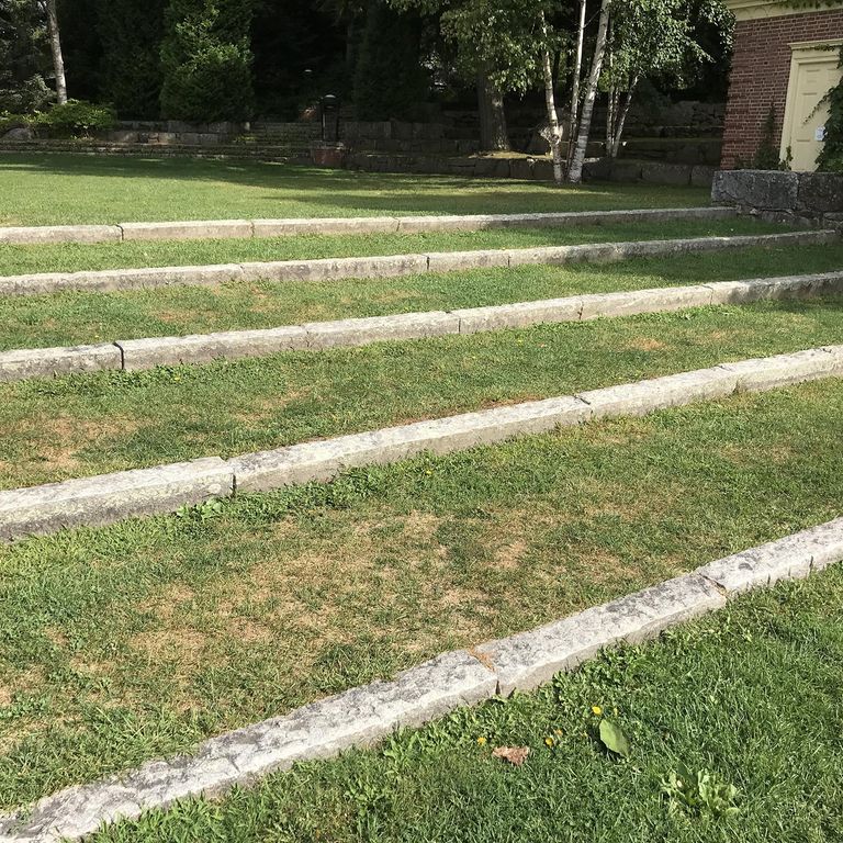 Application image for Reclaimed First Generation Granite Curbstone - Lawn Steps. The image shows this product being used in a monolithic steps application. This is a building and landscape stone for outdoor commercial and residential applications. Suitable for general use, freeze-thaw conditions, low heat absorption surfaces, high traffic areas and low slipperiness surfaces situations. Moderate to higher on the price spectrum.