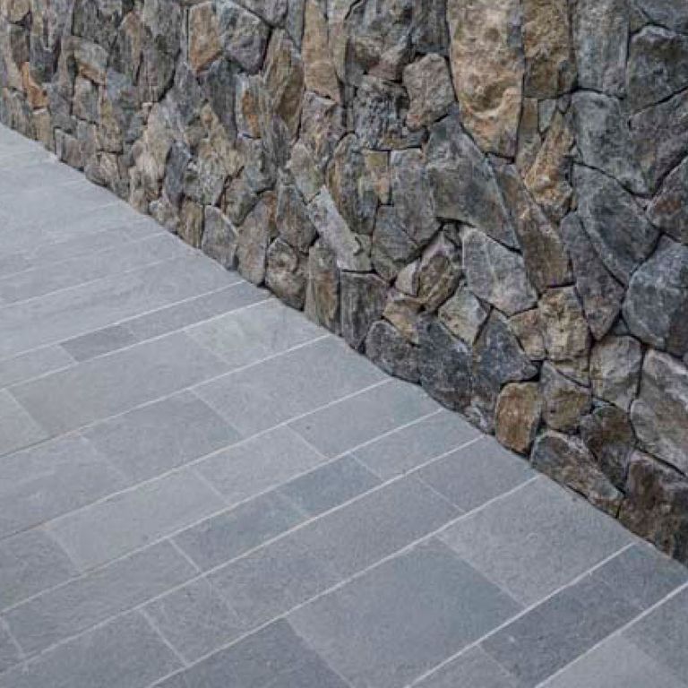Application image for Quartzite - Greek Slate - Grey - Dimensional Sawn Pavers. The image shows this product being used in a path pavers application. The dominant color shown is gray.