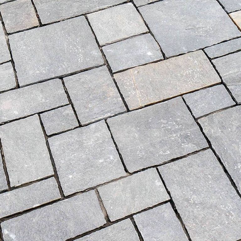 The image shows this product being used in a driveway pavers application.