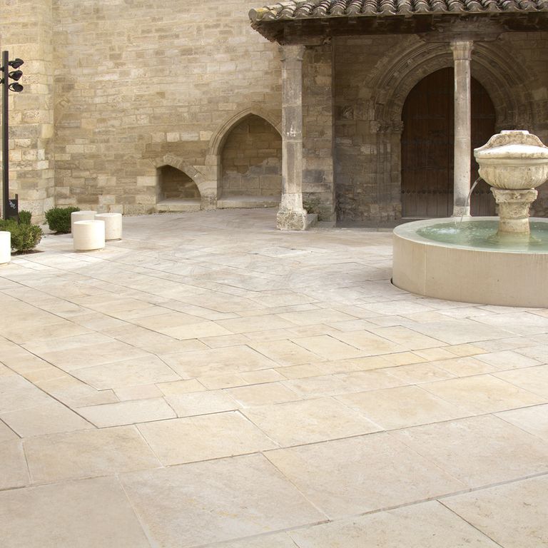 Feature image for Limestone - Cream Pavers. The image shows this product being used in a patio pavers application. Dominant colors shown are beige, tan and cream; with brown and orange/rust secondaries. Exhibits 