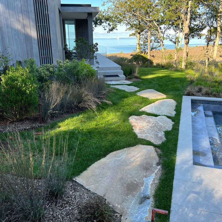 Application image for Granite - Black Mountain - Oversized Irregular Pavers - Natural top. The image shows this product being used in a path pavers application. The surface finish shown is natural. Dominant colors shown are blue and gray.