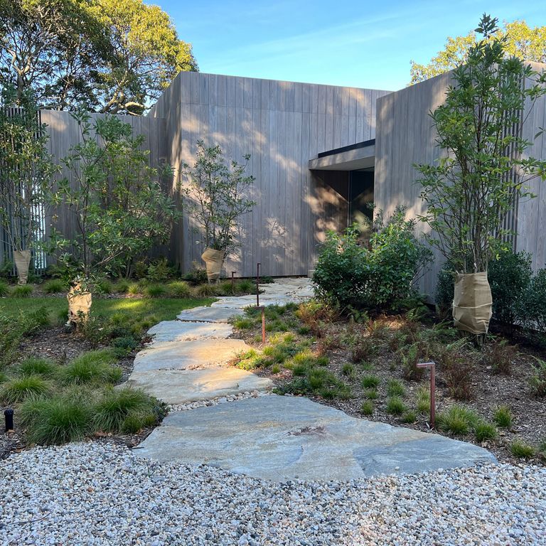 Application image for Granite - Black Mountain - Oversized Irregular Pavers - Natural top. The image shows this product being used in a path pavers application. Dominant colors shown are blue and gray.