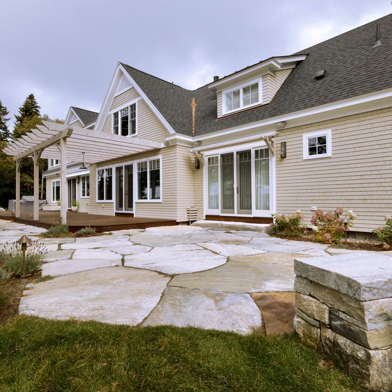Application image for Granite - Black Mountain - Oversized Irregular Pavers - Natural top. The image shows this product being used in a patio pavers application. The dominant color shown is gray. The color mix creates a warm feeling.