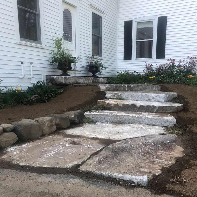 Application image for Granite - Black Mountain - Oversized Irregular Pavers - Natural top. The image shows this product being used in a path pavers application. The dominant color shown is gray. The color mix creates a cool feeling.