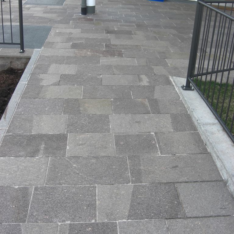 Application image for Porphyry - Natural Surface - Mixed Gray - Pavers. The image shows this product being used for path pavers and patio pavers. The dominant color shown is gray.