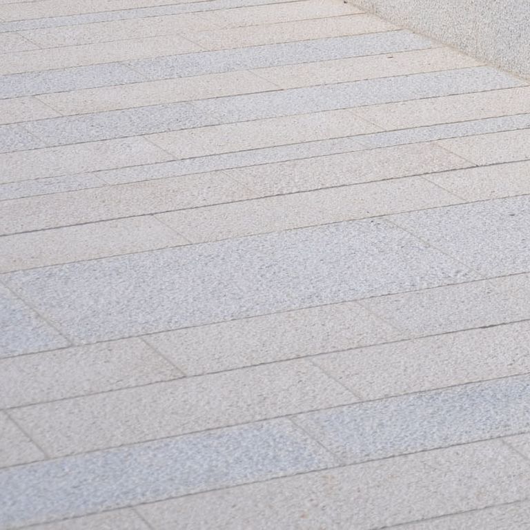 Close-up image for Mountain Hard Limestone Mix - Plank Pavers. The surface finish shown is pineapple. Dominant colors shown are beige, gray and white; with blue, pink and purple secondaries. The color mix creates a cool feeling. Regular and fine speckled color patterns.