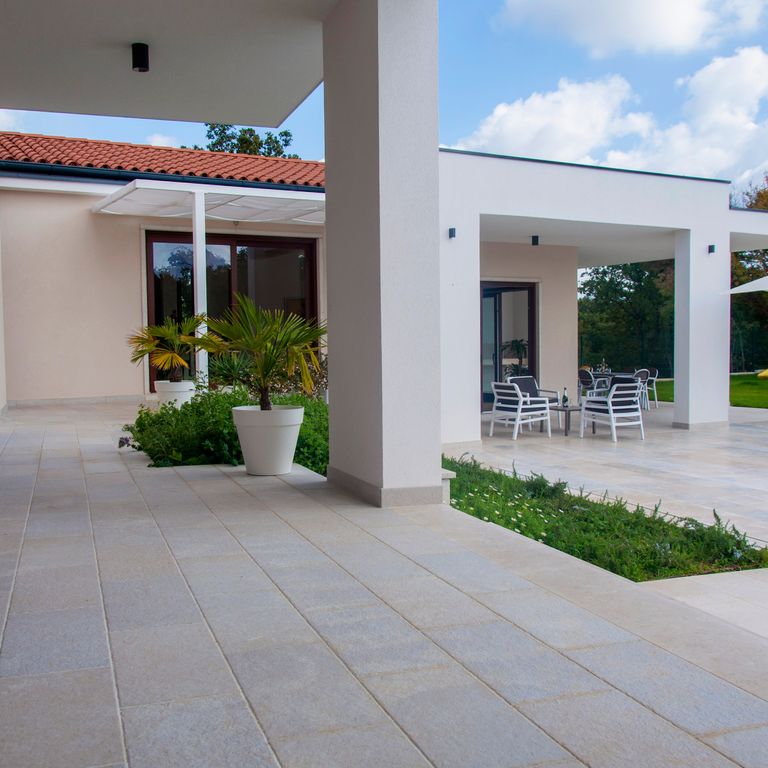 The image shows this product being used for path pavers and patio pavers.