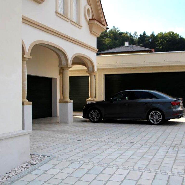 Application image for Limestone - Mountain Hard - Cobblestones Mix. The image shows this product being used in a driveway pavers application. The dominant color shown is beige.