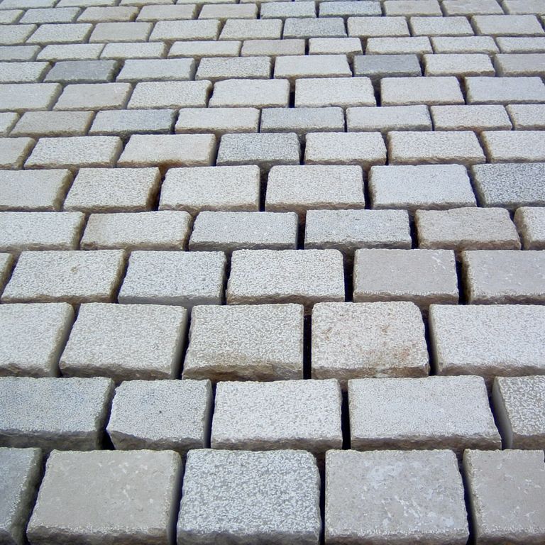 Application image for Limestone - Mountain Hard - Cobblestones Mix. The image shows this product being used in a patio pavers application. Dominant colors shown are gray and tan.