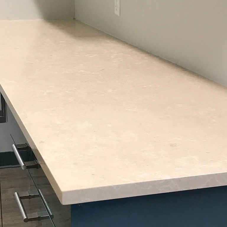 Close-up image for Mountain Hard Limestone Beige - Countertop Slabs. The surface finish shown is polished. Dominant colors shown are beige, tan and cream; with gray and white secondaries. Exhibits 