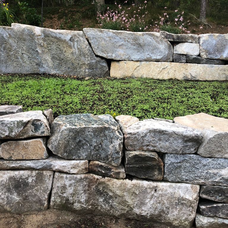 The image shows this product being used in a landscape wallstone application.