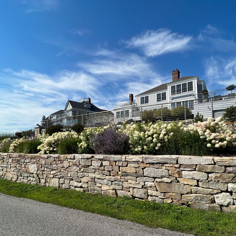Application image for Black Mountain Granite Natural - Wallstone. The image shows this product being used in a landscape wallstone application. Dominant colors shown are beige and tan. The color mix creates a warm feeling.