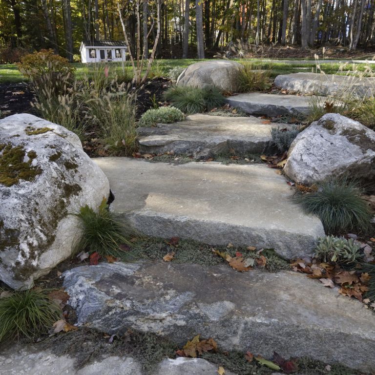 Application image for Granite - Black Mountain - Live Edge Steps. The image shows this product being used in a monolithic steps application. The surface finish shown is natural. The dominant color shown is gray. The color mix creates a warm feeling.