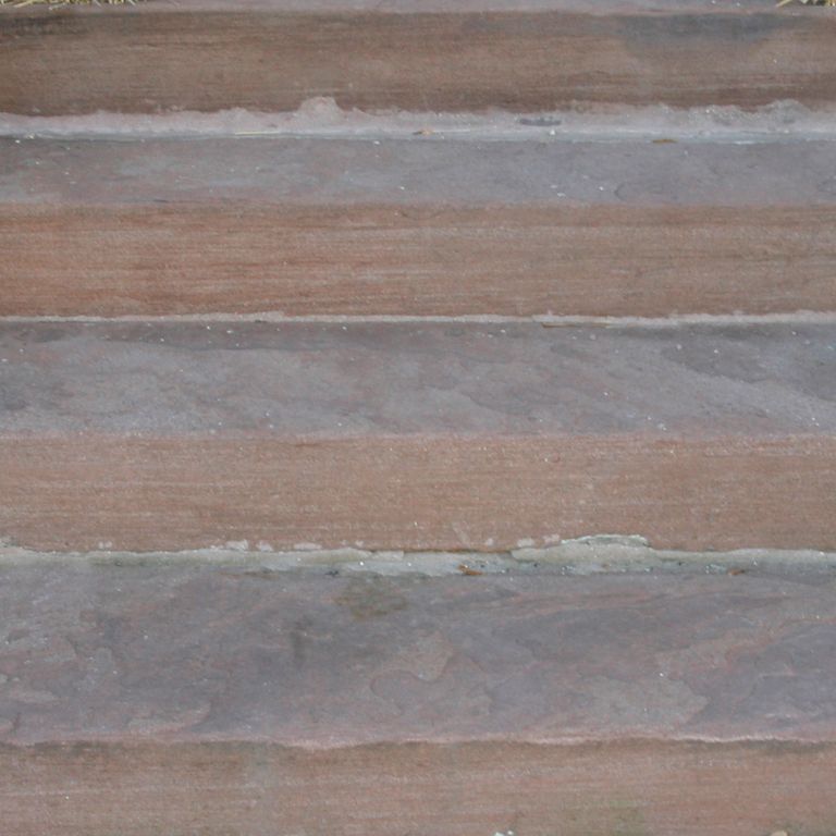 Close-up image for Reclaimed Brownstone Steps. The surface finish shown is flamed. Dominant colors shown are gray and purple; with brown and orange/rust secondaries. Exhibits 