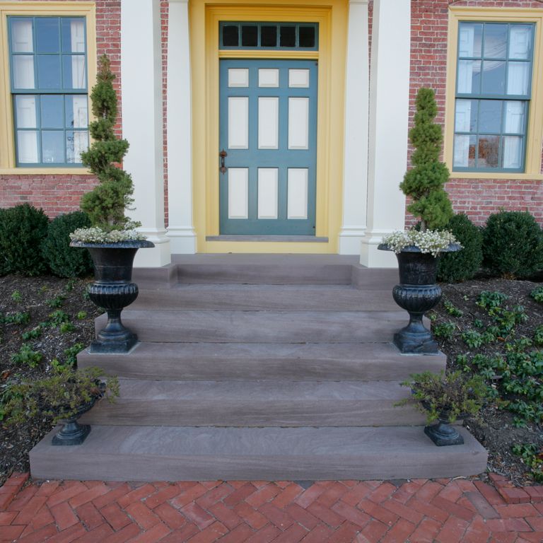 Feature image for Reclaimed Brownstone Steps. The image shows this product being used in a monolithic steps application. The dominant color shown is gray; with blue, brown and purple secondaries. Solid and cloudy color patterns.