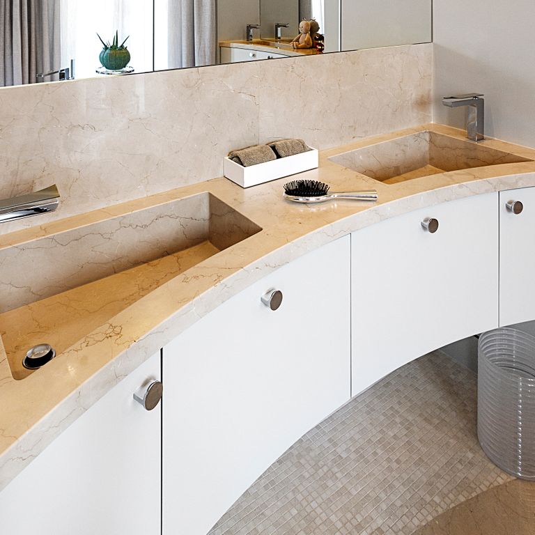 Feature image for Mountain Hard Limestone Beige - Integrated Sink. The image shows this product being used for countertop slabs and sinks. The dominant color shown is beige; with brown, white, tan and cream secondaries. Exhibits 