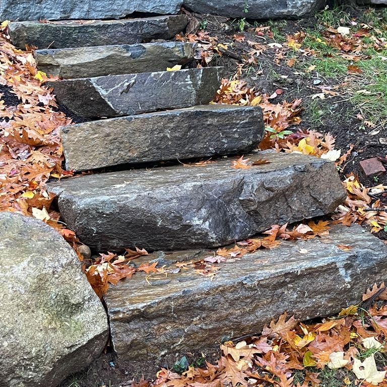 Application image for Mystic Mountain Natural - Steps & Landings. The image shows this product being used in a monolithic steps application. The surface finish shown is natural cleft. Dominant colors shown are blue and gray; with brown, green and purple secondaries. The color mix creates a cool feeling.