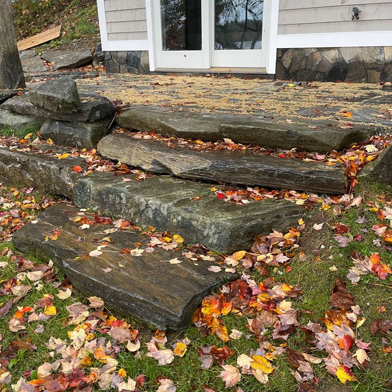 Application image for Mystic Mountain Natural - Steps & Landings. The image shows this product being used for landings and monolithic steps. The surface finish shown is a combination of natural cleft and natural. Dominant colors shown are brown and gray; with green and tan secondaries.