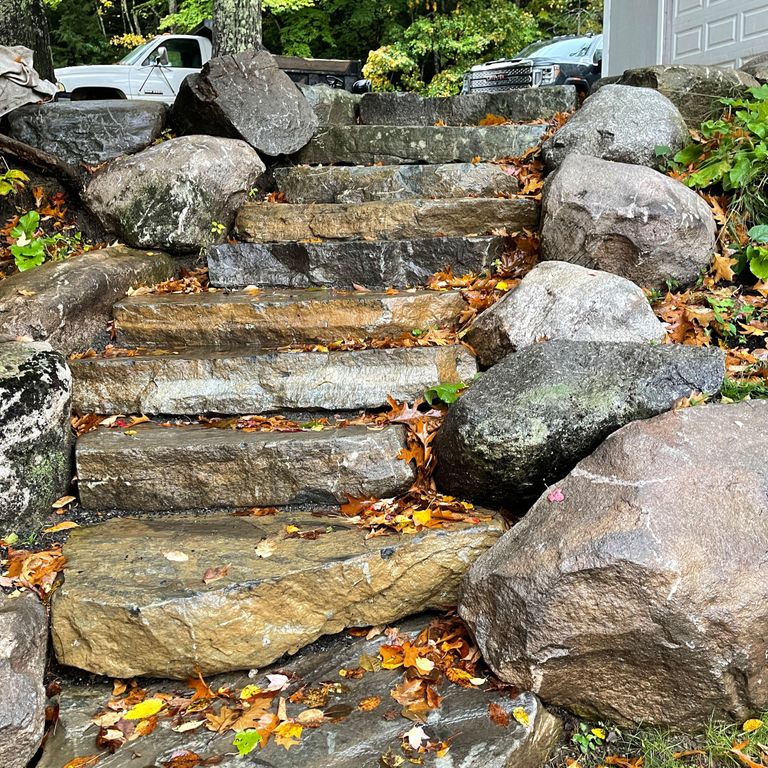 Application image for Mystic Mountain Natural - Steps & Landings. The image shows this product being used in a monolithic steps application. The surface finish shown is natural cleft. Dominant colors shown are brown and gray; with orange/rust, white and tan secondaries. The color mix creates a warm feeling.
