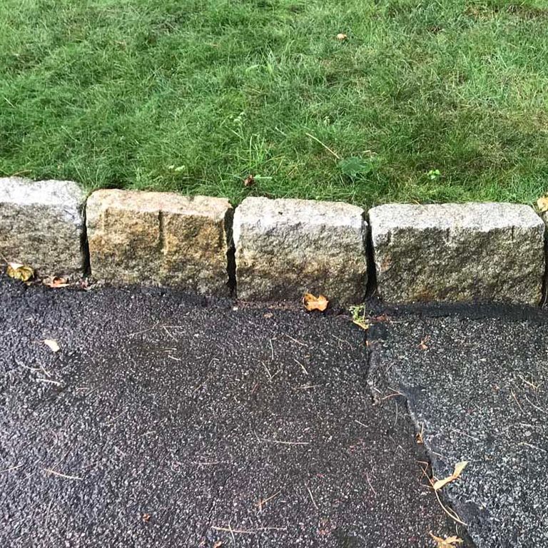 Close-up image for Reclaimed New England Granite Cobblestones - Super Jumbo Edging. The surface finishes shown are split-face, weathered and worn. The dominant color shown is gray; with beige, brown, green, orange/rust, white and tan secondaries. Exhibits 