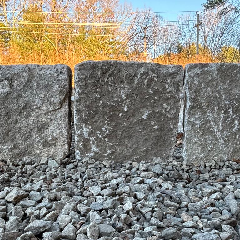 Application image for Granite - Reclaimed New England Cobblestones - Super Jumbo Edging. The image shows this product being used in a landscape curbing & edging application. The dominant color shown is gray. The color mix creates a warm feeling.