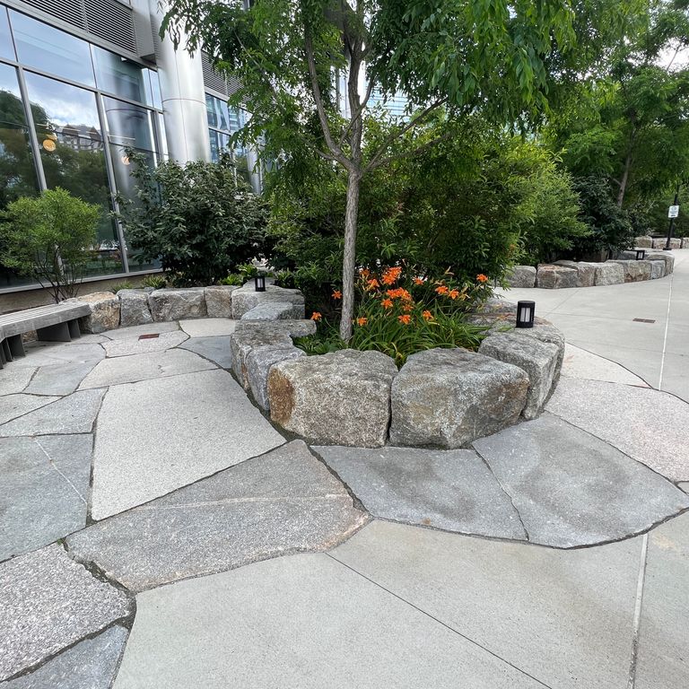 Application image for Granite - New England Mix - Live Edge Paver. The image shows this product being used for patio pavers and public area. Dominant colors shown are gray and white. The color mix creates a cool feeling.