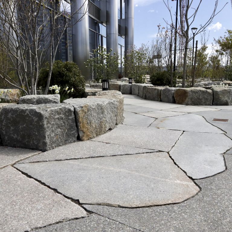 Application image for Granite - New England Mix - Live Edge Paver. The image shows this product being used for patio pavers and public area. The dominant color shown is gray. The color mix creates a cool feeling.