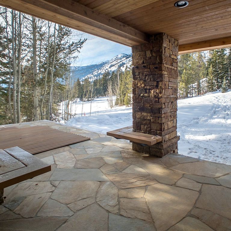 Feature image for Mandarin Yellow Slate - Irregular Pavers. The image shows this product being used in a patio pavers application. Dominant colors shown are beige, gray and tan; with brown, green, orange/rust and purple secondaries. The color mix creates a warm feeling. Random color pattern.