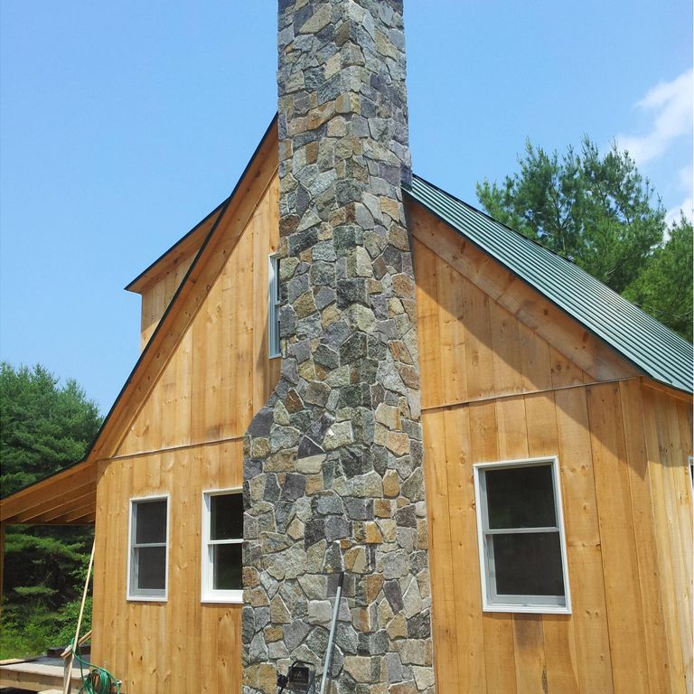 Application image for American Mist Granite - Pavers. The image shows this product being used in a columns application. Dominant colors shown are blue and brown. The color mix creates a cool feeling.