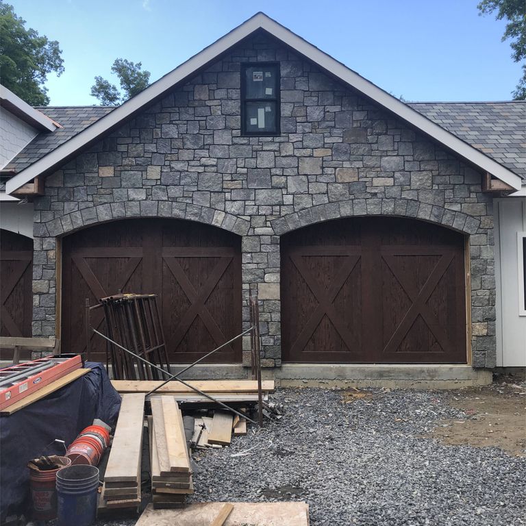 Feature image for Lake Champlain Granite - Veneer. The image shows this product being used in a full bed veneer application. The dominant color shown is gray; with beige, blue, brown, green, purple, white and tan secondaries. The color mix creates a cool feeling. Speckled and cloudy color patterns.