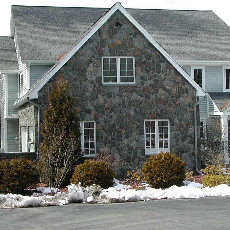 Feature image for Lake George Granite - Veneer. The image shows this product being used in a full bed veneer application. Dominant colors shown are black, brown, green and gray. Exhibits 