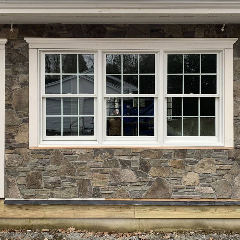 Feature image for Old Yankee Fieldstone - Veneer. The image shows this product being used in a full bed veneer application. Dominant colors shown are brown and gray; with beige, purple, tan and cream secondaries. Exhibits 