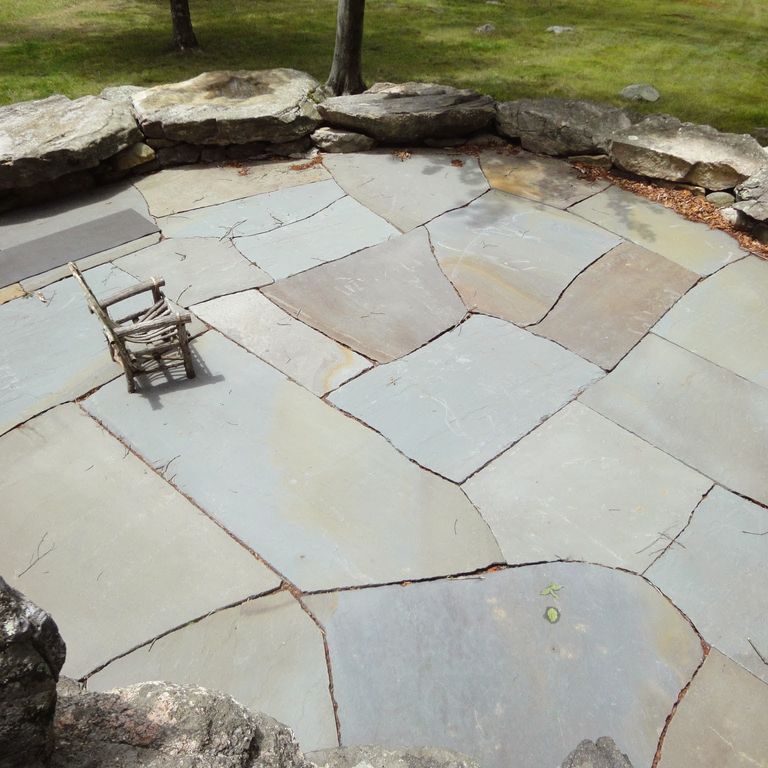 Application image for Bluestone Natural Cleft Full Color Mix - Irregular Pavers - Jumbo. The image shows this product being used in a patio pavers application. The surface finish shown is natural cleft. The dominant color shown is gray. The color mix creates a warm feeling.