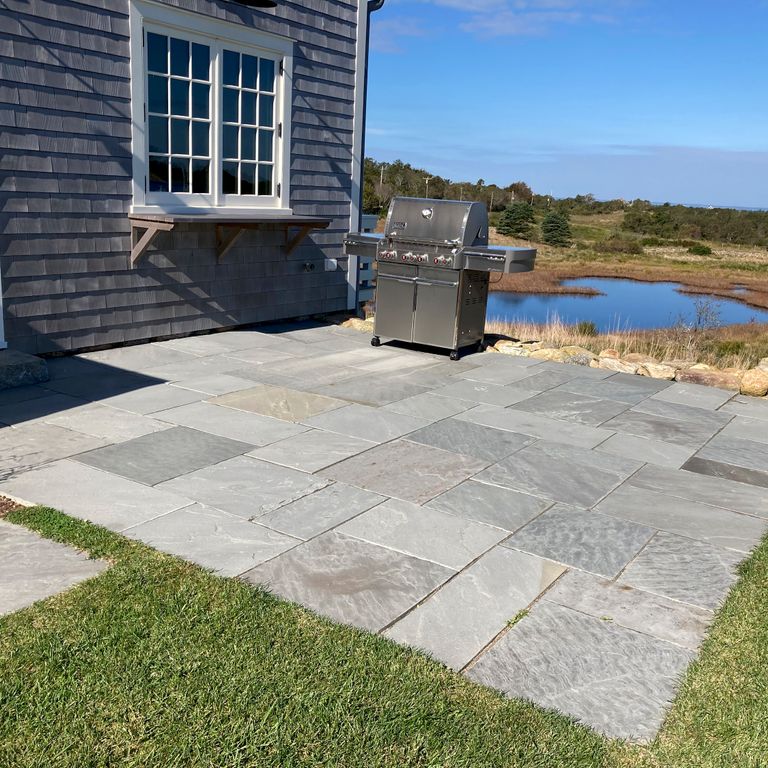 Application image for Bluestone Natural Cleft Blue/Gray - Dimensional Cut Pavers. The image shows this product being used in a patio pavers application. Dominant colors shown are blue and gray. The color mix creates a cool feeling.