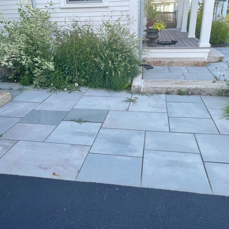 Application image for Bluestone Flamed Surface Blue/Gray - Dimensional Cut Pavers. The image shows this product being used for path pavers and patio pavers. The surface finish shown is flamed. Dominant colors shown are blue and gray. The color mix creates a cool feeling. Solid color pattern.