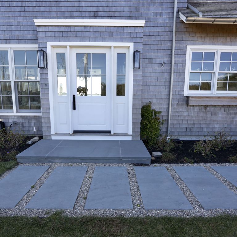 Application image for Bluestone Flamed Surface Blue/Gray - Dimensional Cut Pavers. The image shows this product being used in a path pavers application. The surface finish shown is flamed. Dominant colors shown are blue and gray. The color mix creates a cool feeling.