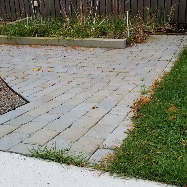 The image shows this product being used in a path pavers application.