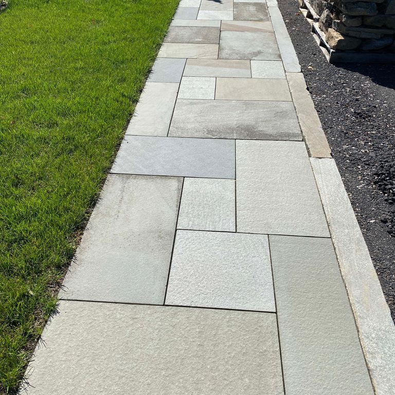 The image shows this product being used in a path pavers application.
