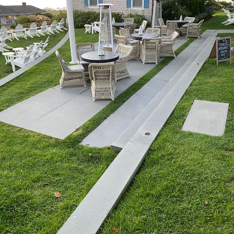 Application image for Blue/Gray Bluestone - Flamed Monolithic Steps. The image shows this product being used for monolithic steps and treads. Dominant colors shown are blue and gray; with blue and white secondaries. The color mix creates a cool feeling. Solid color pattern.