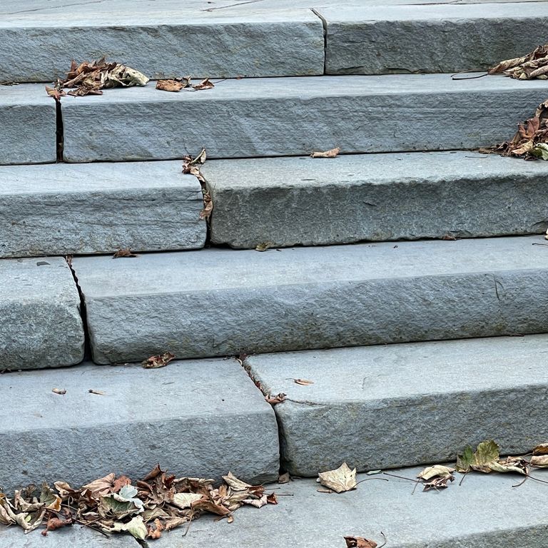 Application image for Bluestone Flamed Surface Blue/Gray - Monolithic Steps. The image shows this product being used in a monolithic steps application. The surface finish shown is flamed. Dominant colors shown are blue and gray. The color mix creates a cool feeling. Solid color pattern.